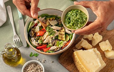 Insalata saporita di pollo arrosto sfilacciato con verdure di stagione grigliate, salsa verde e scaglie di Grana Padano